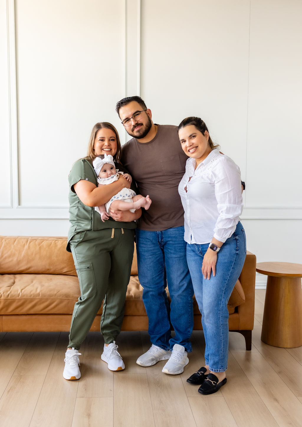 A family posing with Brittany Shockley, who holds their infant
