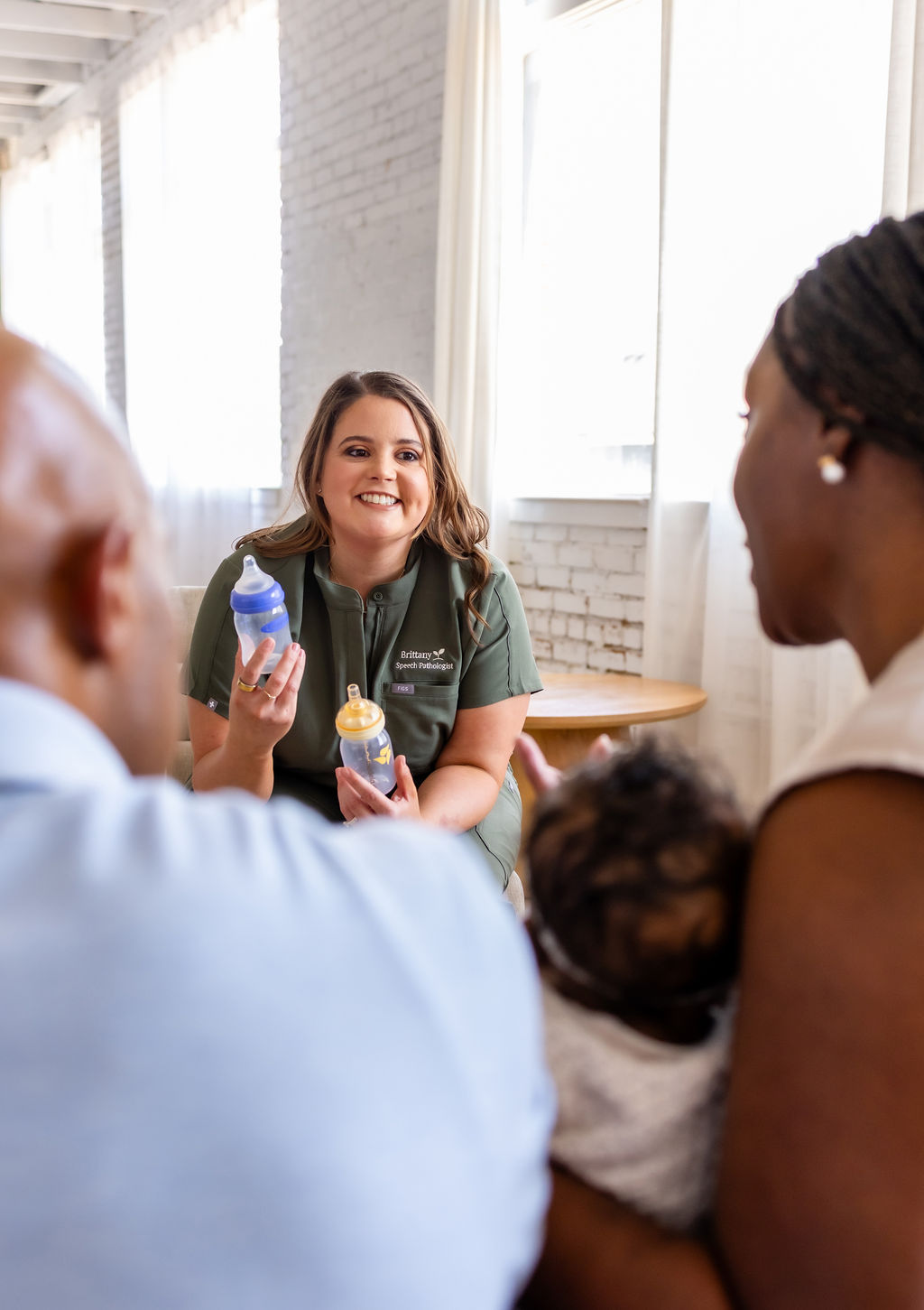 Brittany Shockley discussing baby bottles with a family