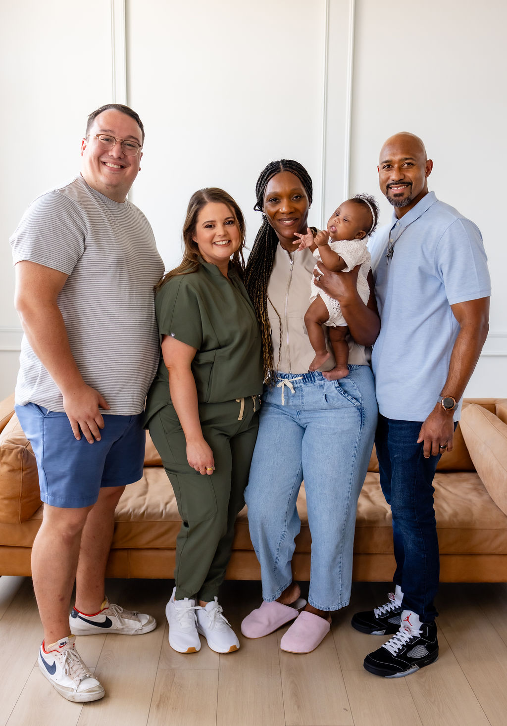 A family with an infant posing with Brittany Shockley and another adult