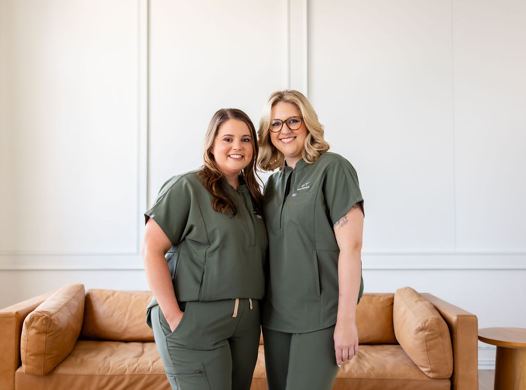 Co-founders Brittany Shockley and Ally Gore standing together in green scrubs